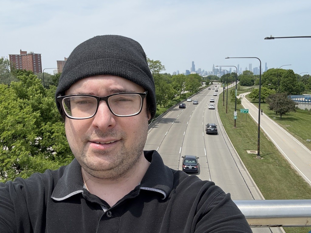 Carl Rice on a pedestrian bridge with the Chicago skyline in the background